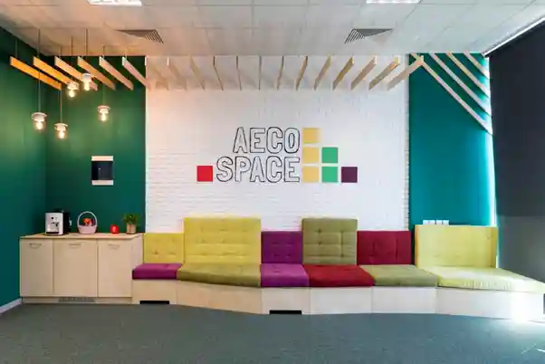post construction photo of interior elevation by 3DEA with colourful writing on white brick wall and colourful couche