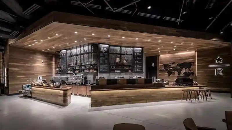 Starbucks reserve bar with concrete floors and wooden walls and wooden bar and furniture